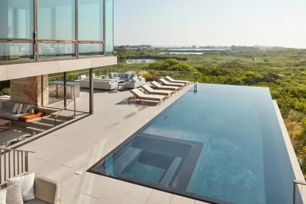 A mesmerizing view of The Dune House, seamlessly blending with the surrounding natural landscape