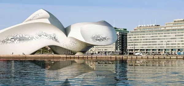 The Guggenheim Helsinki, an iconic waterfront museum, gracefully positioned by the water