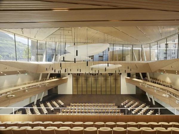 Andermatt Concert Hall's design integrating the Swiss Alps landscape into the cultural experience.