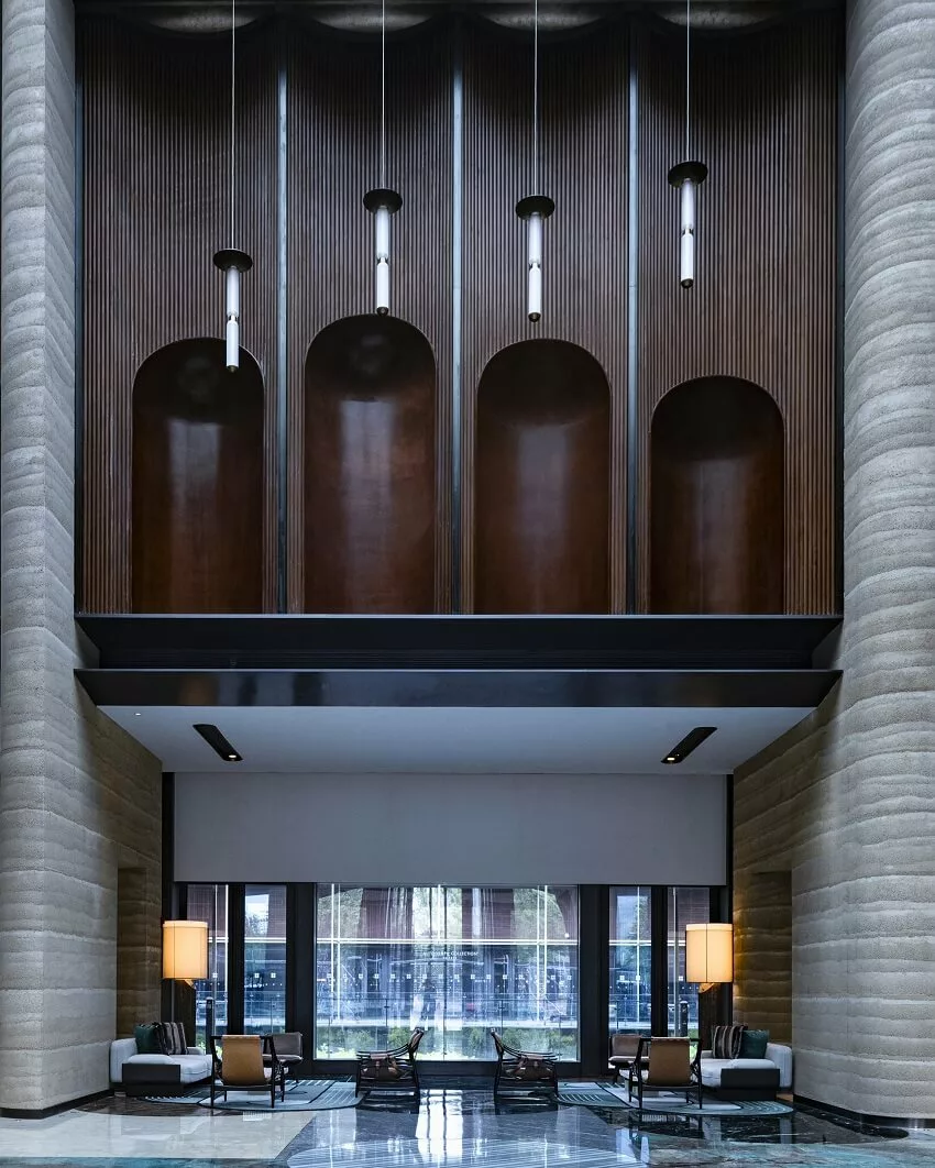 Spacious lobby of the AUTOGRAPH COLLECTION HOTEL in Nanjing, China, featuring industrial elements, captured by Jinfeng Qiu.