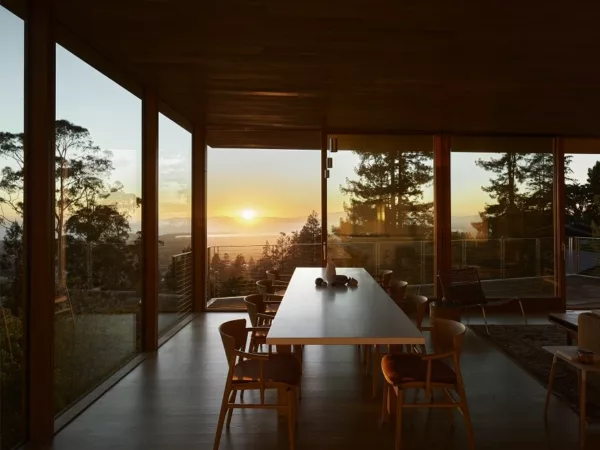 Interior view of Buena Vista House with a glass wall providing views of the surrounding nature, designed by Jasmit Rangr.