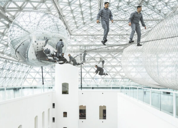 Visitors walking inside the suspended net of In Orbit – K21.