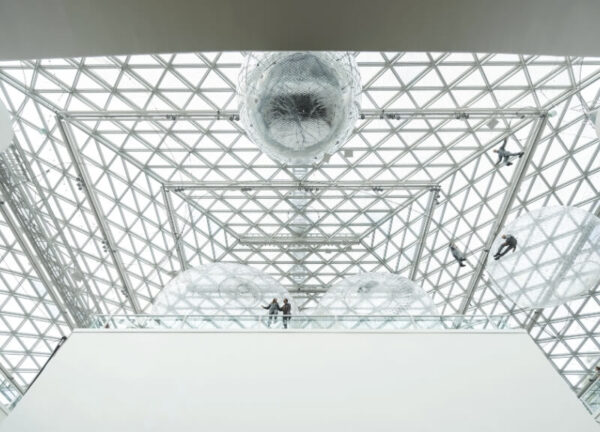 View of Saraceno’s net structure against K21’s geometric glass roof.