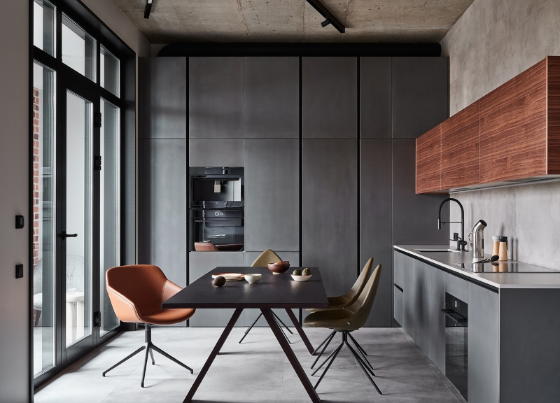 Kitchen and dining area with large wall windows in a Moscow loft apartment.