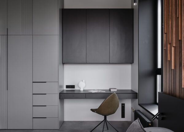 Second workspace on the opposite side of the bedroom in a loft-style apartment.