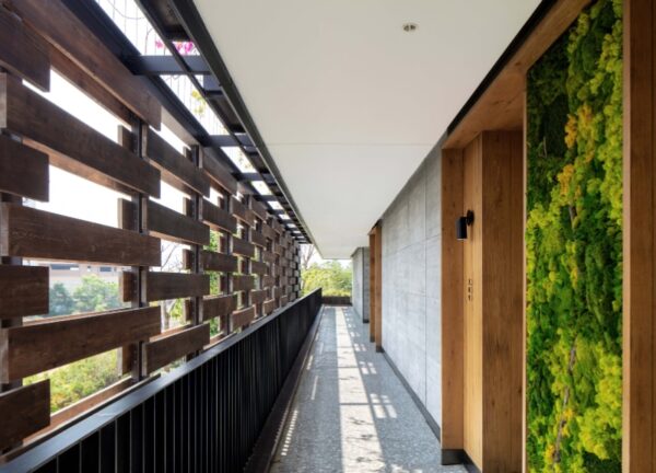 Interior hallway and balcony at 1 Hotel Haitang Bay, featuring living walls and open corridors.