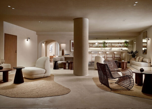 Spacious living room with bar at Domes Noruz Mykonos, showcasing whitewashed curves.