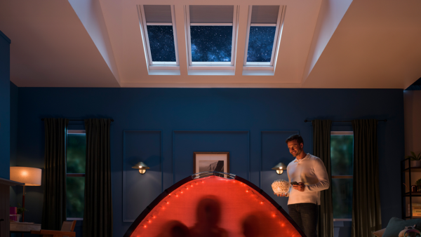 Skylight with integrated shade partially closed in a bright room